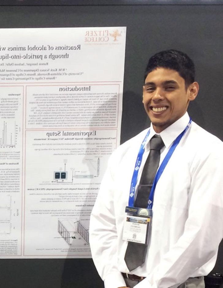 Pitzer alumnus Ramon Jauregui stands next to a poster that he presented to legislators in Washington, D.C.