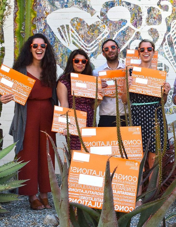 admission officers hold up congratulations signs for early decision students